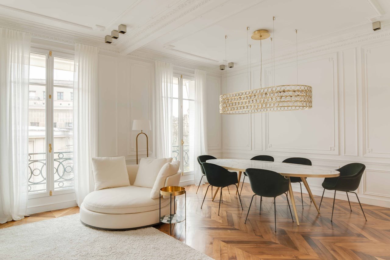 who-we-are Sophisticated white-themed room with modern furniture and chic decor, perfect for elegant gatherings.