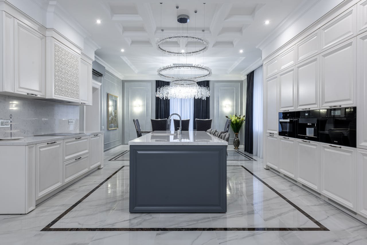services-03 Interior of contemporary spacious kitchen with light expensive furniture placed in apartment with minimalistic design