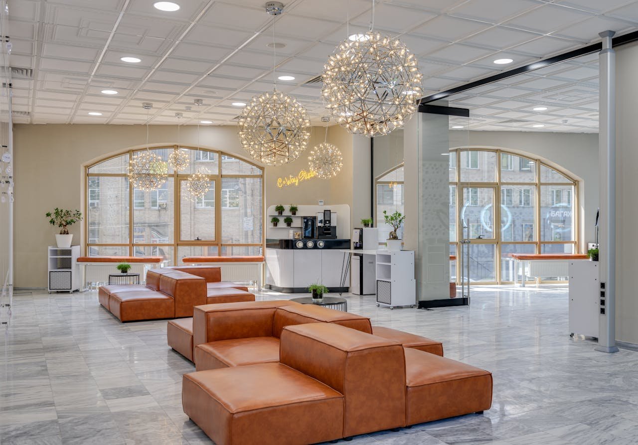 services-04 Spacious office lobby featuring stylish leather seating and stunning chandeliers.